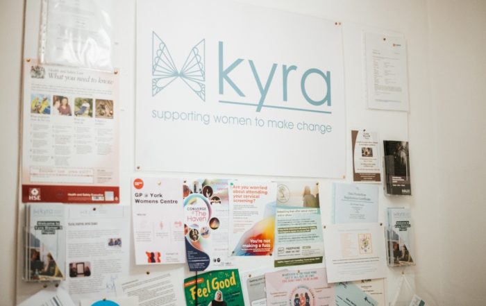 Interior, a notice board at Kyra bearing many pamphlets and leaflets, for “Our New Managing Emotions Workshop: Tools to Build Resilience and Emotional Intelligence”