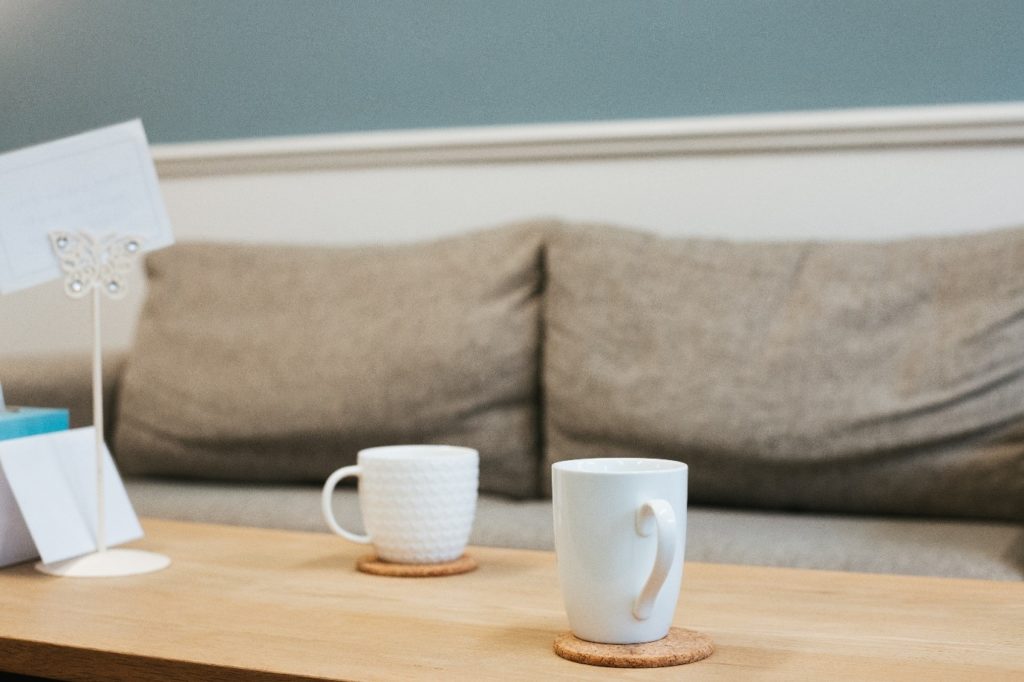 Interior, a coffee table with two mugs in a comfy living room, for “Understanding, Support, and Space: Kyra’s Neurodiversity Group”