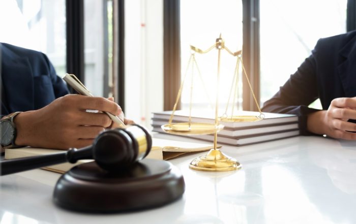 Interior, two people sitting across a table with scales and a gavel, for “Let’s Talk Legal Advice: How Kyra Helps You Understand Your Rights”