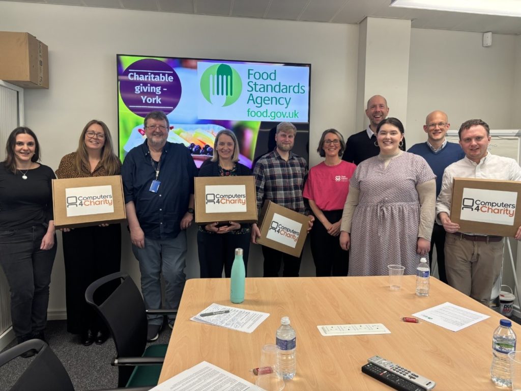 Several people holding carboard boxes with ‘Computers 4 Chairty’ written across the front, for “Tech That Makes a Difference: FSA’s Laptop Donation to Kyra”